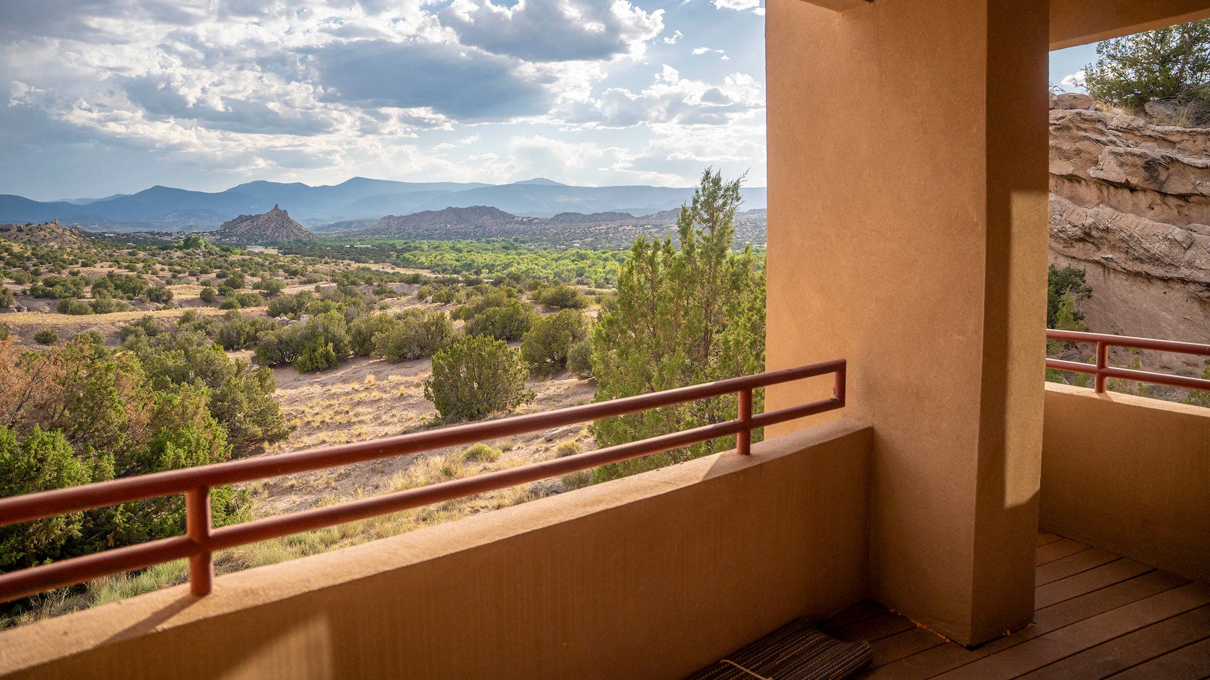 Covered adobe terrace overlooking the high-desert mesa and distant mountains